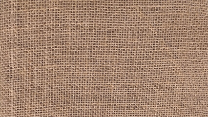 Hessian sackcloth woven fabric texture background in beige cream brown color. 