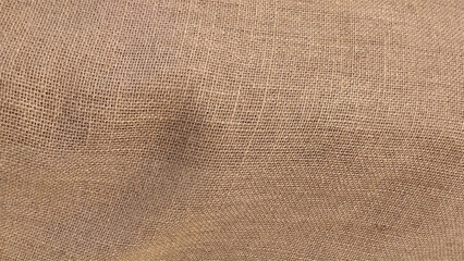 Hessian sackcloth woven fabric texture background in beige cream brown color. 