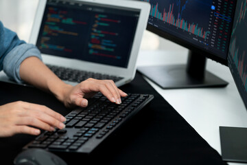Cropped hands image of IT developer creating with typing information on pc with coding program information data website application, wearing jeans shirt surround safety analysis two screen. Stratagem.