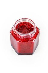 Top view of fresh, vibrant red currant berry jam in an open glass jar, perfect for breakfast spreads or desserts. Closeup. Copy space. Isolated on white background. 
