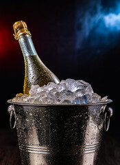 Bottle of sparkiling wine in bucket with crushed ice. © monticellllo
