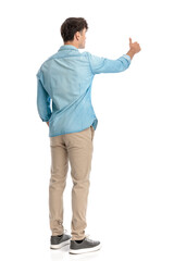 back view of casual man making thumbs up gesture