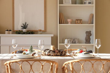 Beautiful table setting with Christmas decorations and candles in living room