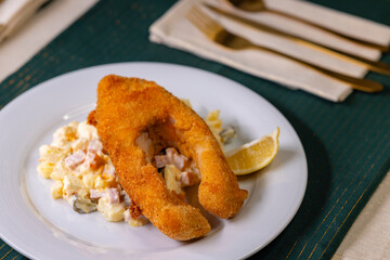 Traditional Christmas dinner in Czech Republic - fried carp with potato salad