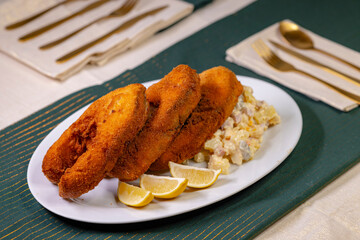 Traditional Christmas dinner in Czech Republic - fried carp with potato salad