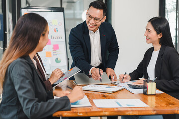 Professional team collaborating in modern office, discussing strategies and analyzing data. Engaged individuals share ideas and insights, fostering teamwork and innovation