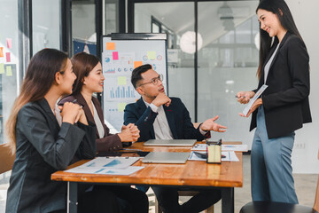 Professional business meeting with diverse team discussing strategies and ideas. Engaged participants share insights in modern office setting, fostering collaboration and innovation