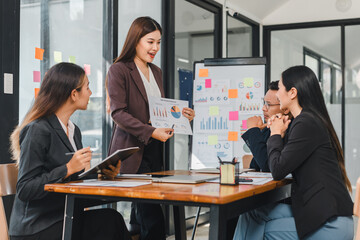 Professional women in business meeting discussing charts and graphs. atmosphere is focused and collaborative, showcasing teamwork and effective communication
