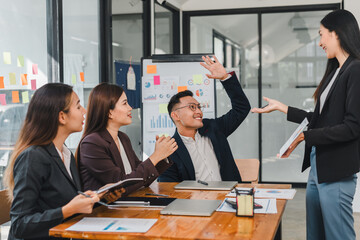 Efficient business meeting with diverse professionals discussing ideas. Engaged team members share insights and collaborate in modern office space