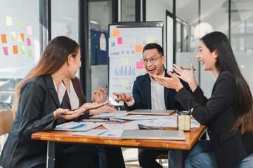 group of professionals engaged in lively discussion around table, sharing ideas and analyzing charts. Their expressions reflect enthusiasm and collaboration