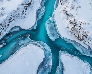 Aerial view of a stunning icy landscape featuring turquoise waters surrounded by snow-covered terrain, showcasing the beauty of winter scenery.
