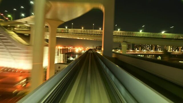 Time-lapse of driverless Yurikamome train running at night, Odaiba night view, Rainbow Bridge, Tokyo, Japan / 夜、タイムラプスで無人運転の電車ゆりかもめの走行シーン　夜景のお台場　レインボーブリッジ　東京　日本