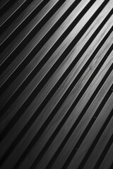 Obraz premium The image is a close up of a black and white striped wooden surface. The stripes are thin and close together, creating a sense of depth and texture. Scene is one of simplicity and elegance