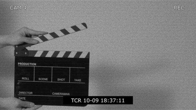 Movie slate or clapperboard hitting with recording frame. Close up hand holding empty film slate and clapping in front of camera clear background. Open and close film slate filming a video production