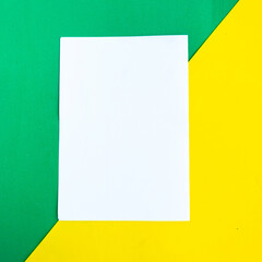 White mockup blank on geometric green and yellow background, copy space for the text