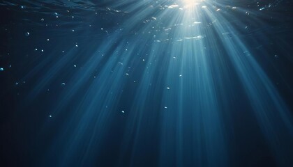 Obraz premium Underwater Sunbeams: A mesmerizing view of sunbeams piercing the deep ocean, creating a dramatic and ethereal underwater scene. The image is filled with mystery and tranquility. 