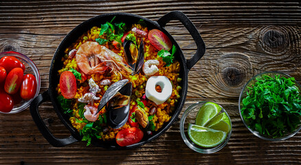 Seafood paella served in a cast iron pan