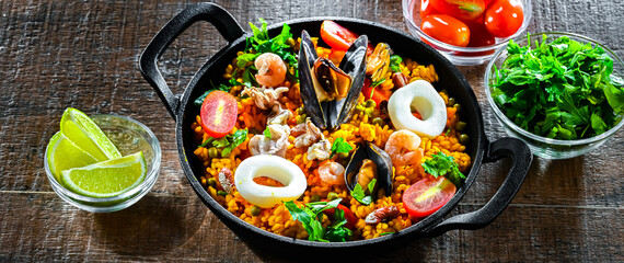 Seafood paella served in a cast iron pan