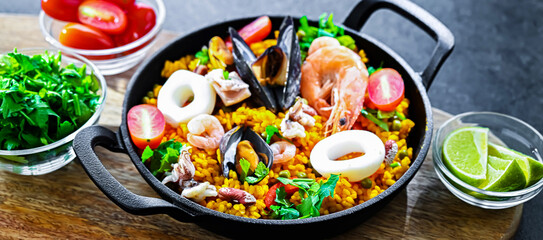 Seafood paella served in a cast iron pan