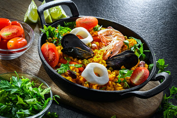 Seafood paella served in a cast iron pan