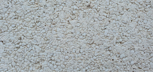 Stone background made of small stones, stone texture. Texture of stone wall, stone tiles, stonework background. Interior and exterior design, facade, fence. Building materials, repairs, construction.