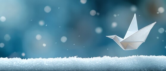  A white origami bird atop a heavy snowpile