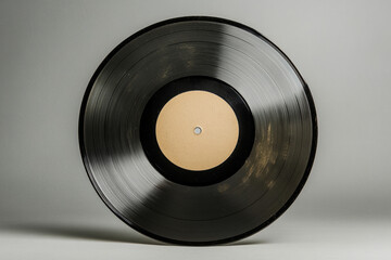 Fototapeta premium A vintage vinyl record displayed against a light background in a studio setting