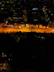 Fototapeta premium Aerial View of Illuminated Central Cambridge City of Cambridgeshire of England UK During Night. High Angle Footage Was Captured with Drone's Camera at Just After Sunset on March 22nd, 2024