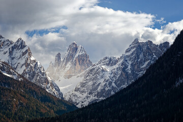 Mountain panorama, sunset light and fog on snow covered peaks of the Sesto Dolomites, South Tyrol, Alps, Italy, Europe