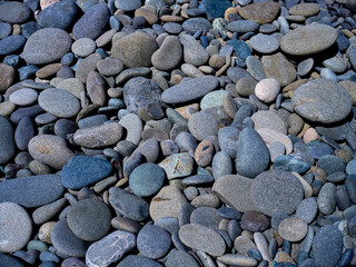 Weathered stones and rocks on the shore of Rialto beach in Washington state