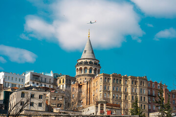 Galata Tower. The plane flies over the Galata Tower in the blue sky. Perfect view.Istanbul, Turkey.