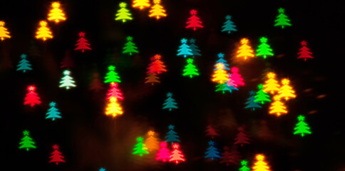 Christmas lights background. Blurred Christmas background, festive multicolor bokeh wallpaper. Holiday Christmas glowing color lights with Christmas tree