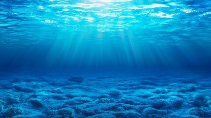 A dark blue ocean surface is seen from underwater. Abstract fractal waves and sunlight shine through