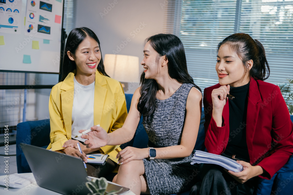 Poster three young businesswomen are sitting on a sofa in a modern office, actively discussing business str