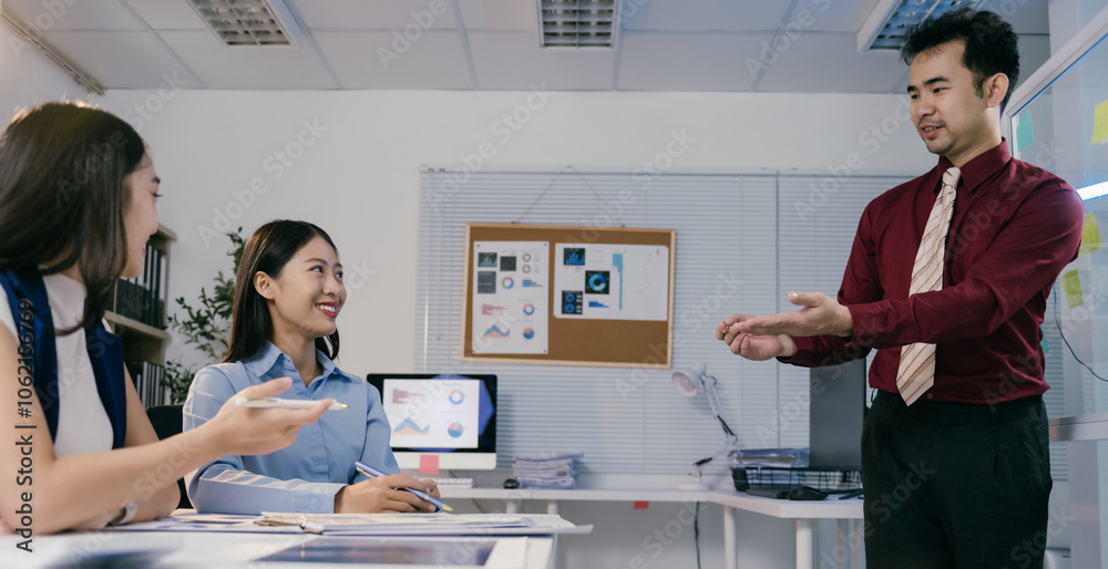Poster asian businessman leads a productive meeting with two female colleagues in a modern office, discussi