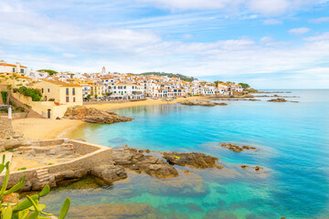 Fototapeta premium The rocky coast, sandy beach and whitewashed village at the fishing town of Calella de Palafrugell, Spain, on the Costa Brava Mediterranean coast. 