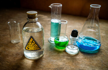 Several glass vessels on the table with chemical liquids.A home laboratory.Dangerous solutions in glass flasks.