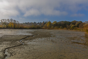 A drained pond and mud on its bottom