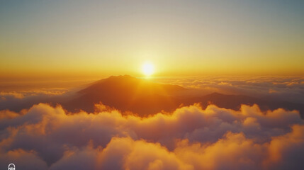 Fototapeta premium Sunrise over mountains surrounded by clouds in a serene morning sky