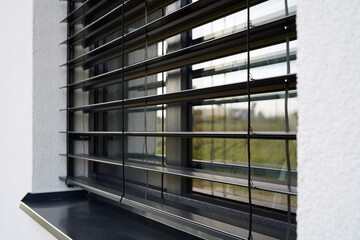Outdoor blinds on the window. We see the individual slats in the color of anthracite.
