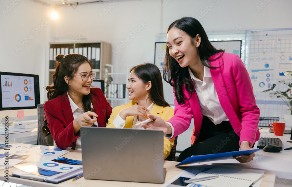 Poster three asian businesswomen are smiling and collaborating on a laptop, discussing work and analyzing c