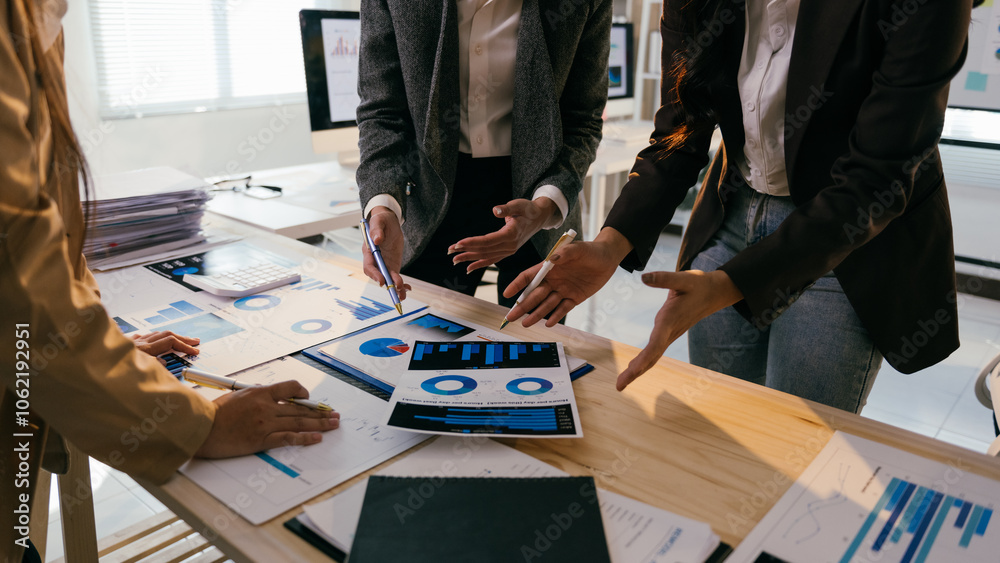Poster businesswomen are analyzing financial data, collaborating on charts and graphs during a productive o