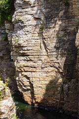 Sunlight Casts Shadows on Rocky Canyon Wall