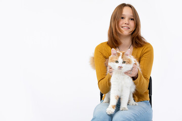 A Cheerful Girl Holding a Sweet Cat in a Cozy Studio Setting Filled with Joy and Warmth