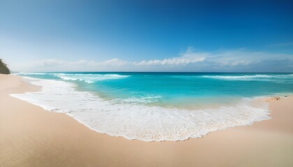 Beautiful sandy beach and soft blue ocean wave horizon view with white clouds on a sunny day