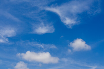 View of white clouds and a blue sky. Azure sky with white clouds in the background.