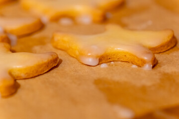 close up of a cookie with a white glaze on it. The cookie is cut in half and the glaze is dripping down the side