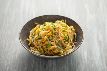Korean soy bean sprouts salad Kongnamul Muchim  with chopsticks. Korean food side dish