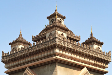 Obraz premium The elaborate roof and turrets, towers of the Patuxai Monument, decorated with a lot of stucco in different shapes and patterns, Vientiane, Laos