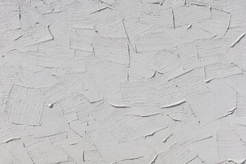 Textured white plaster wall with patterns, background for design or decoration purposes